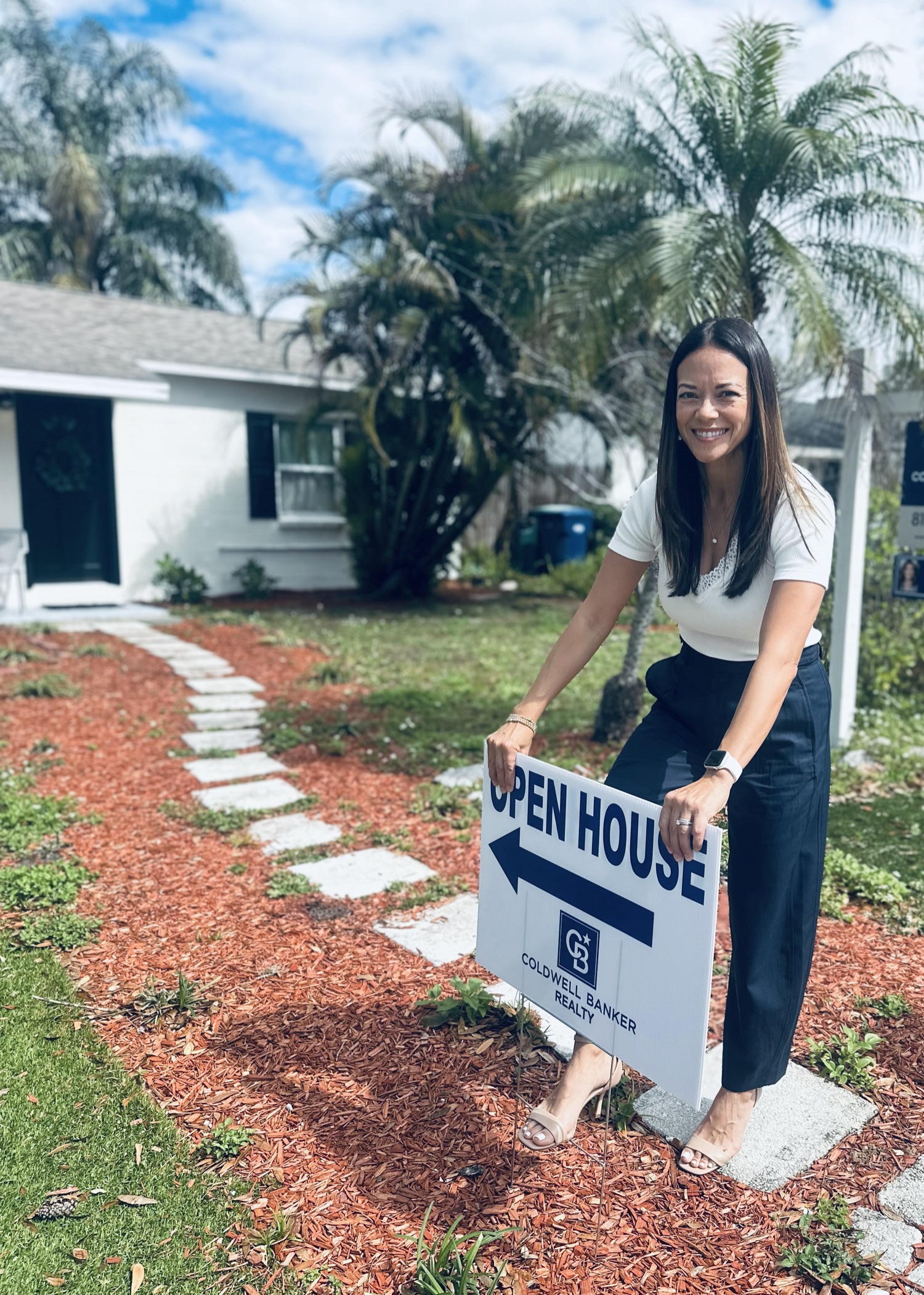 Emily Saunders setting an open house sign in Tampa